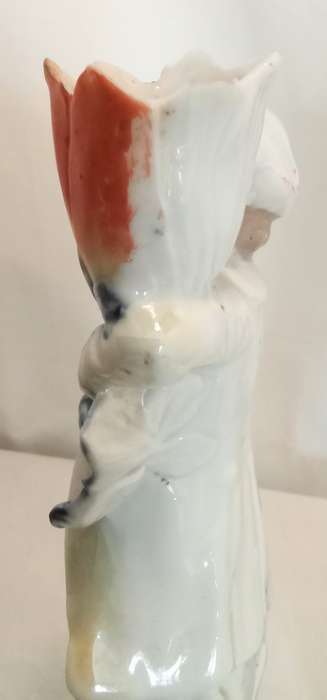 Vintage porcelain couple carrying vases