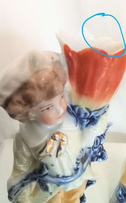 Vintage porcelain couple carrying vases