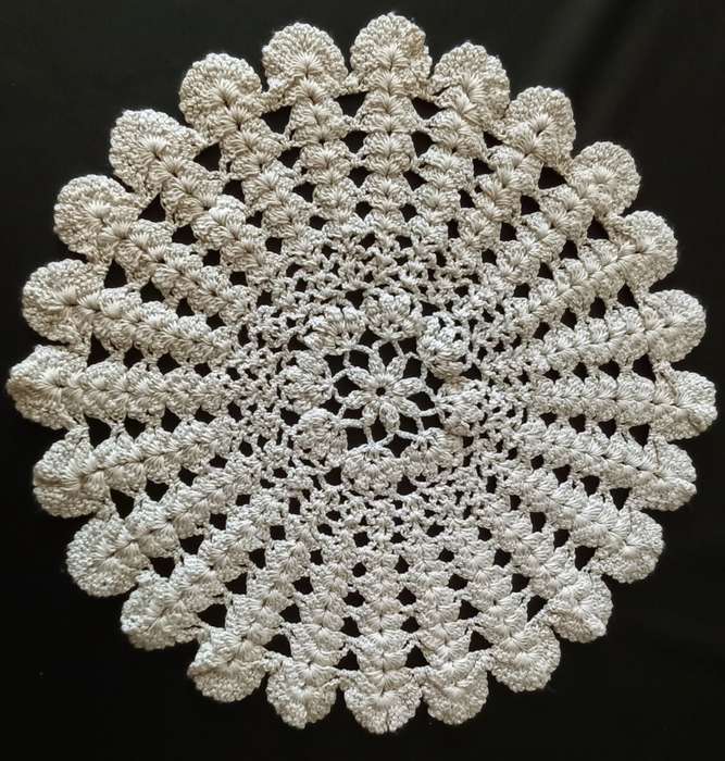 Beautiful beige crocheted doily - about 28cms across
