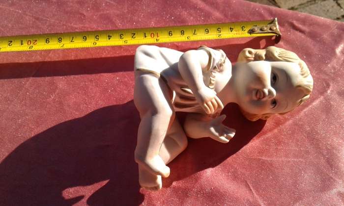 Little girl ornament.  No markings.