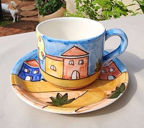 A HANDPAINTED HJ DESIGNS SINGAPORE COFFEE CUP AND SAUCER