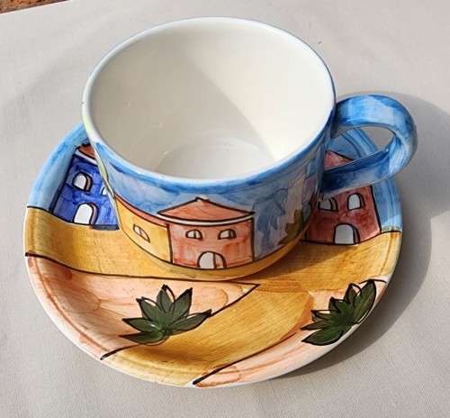A HANDPAINTED HJ DESIGNS SINGAPORE COFFEE CUP AND SAUCER