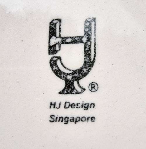 A HANDPAINTED HJ DESIGNS SINGAPORE COFFEE CUP AND SAUCER