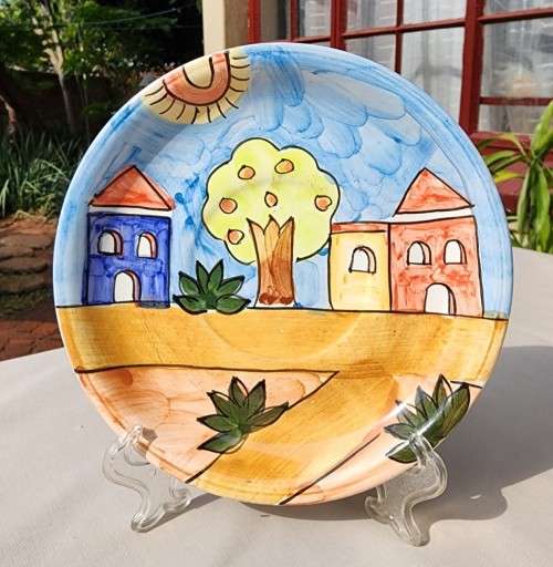 A HANDPAINTED HJ DESIGNS SINGAPORE COFFEE CUP AND SAUCER