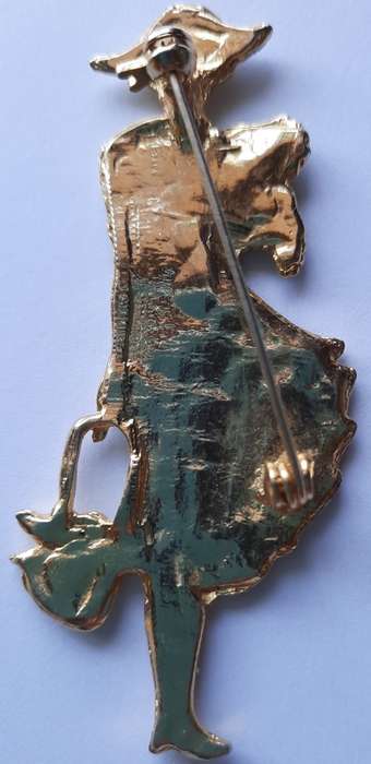 Elegant  woman with a dog and bag brooch