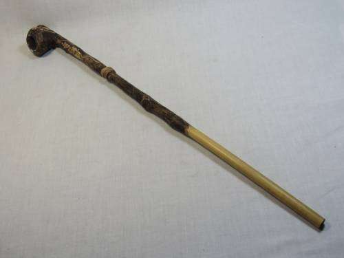 Long bamboo and clay pipe