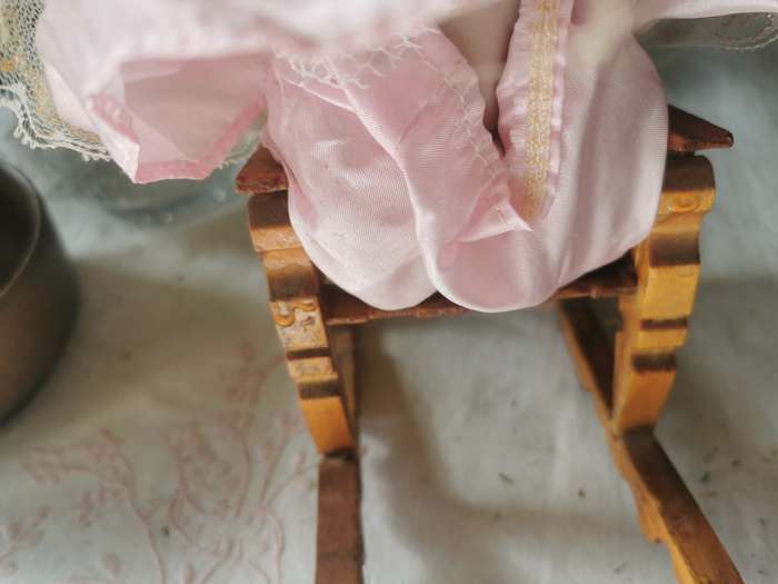 VINTAGE SMALL PORCELAIN DOLL ON ANTIQUE CHAIR