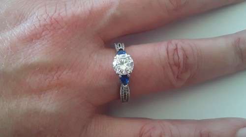 Solid sterling silver trilogy ring with clear centre stone and blue side stones. Size: N (17mm)