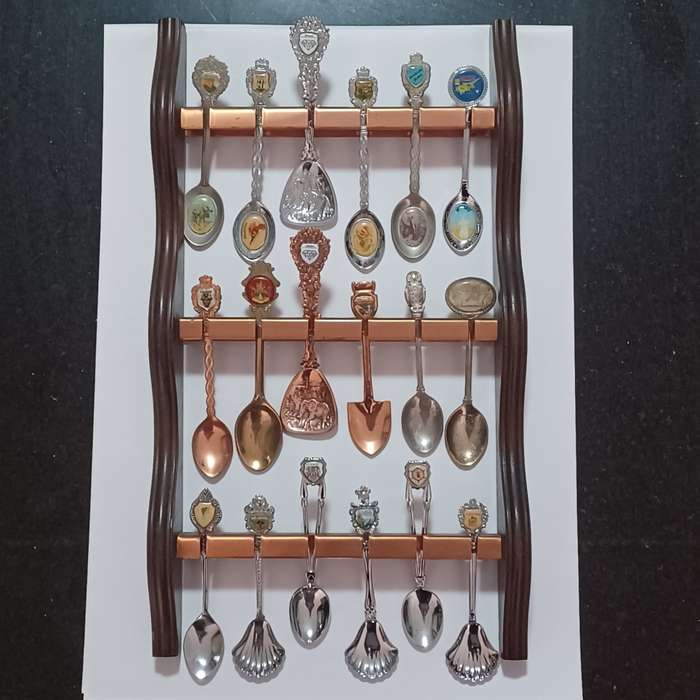Vintage collectable spoons on wall stand