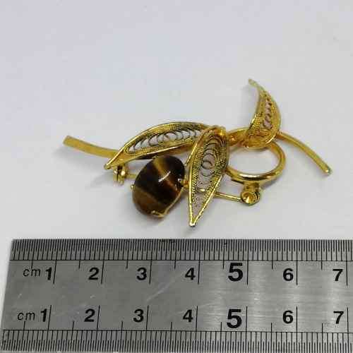 Gold colored fashion jewellery tigers eye brooch