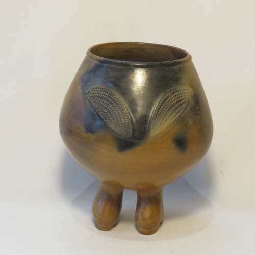Unique clay pot standing on its own feet