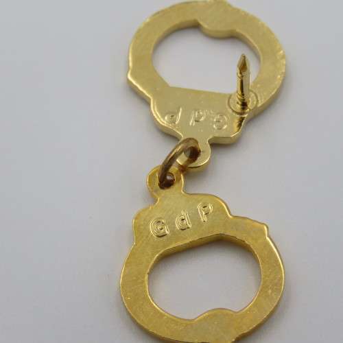 Police handcuffs pin badge