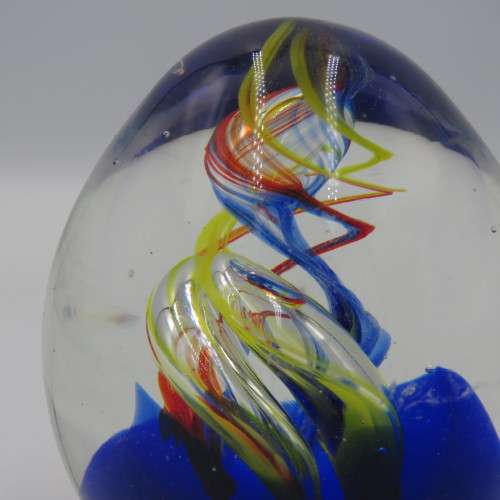 Handmade glass paperweight with spiral design