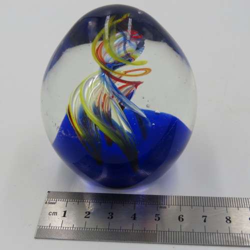 Handmade glass paperweight with spiral design
