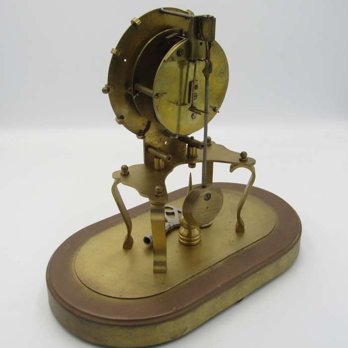 Antique brass skeleton clock with glass dome