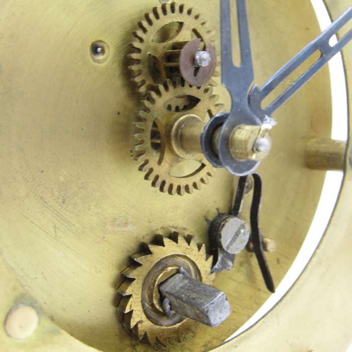 Antique brass skeleton clock with glass dome