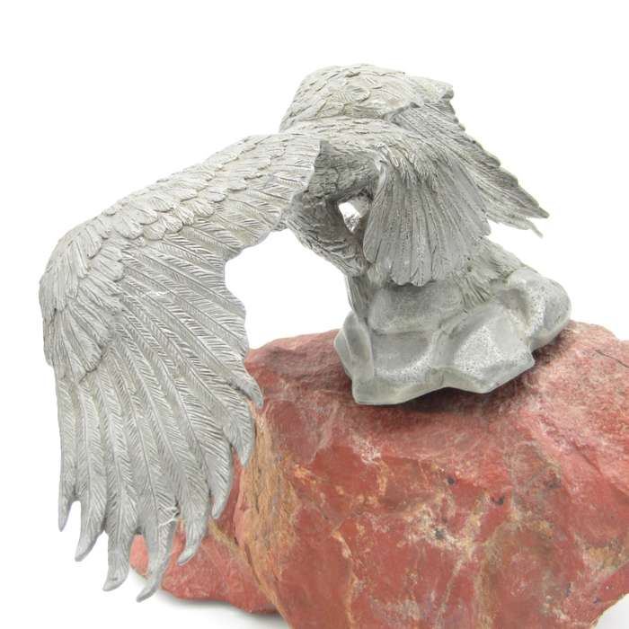 Beautiful white metal eagle sculpture on stone base