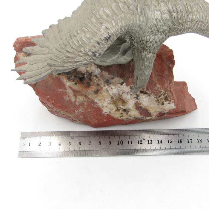 Beautiful white metal eagle sculpture on stone base