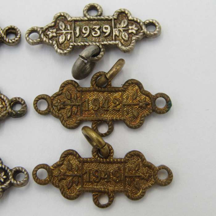 Lot of 9 St John`s Ambulance date labels - some silver
