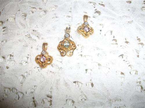Three assorted costume rolled gold pendants