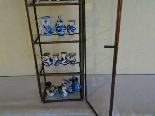 stunning little glass display case with some blue and white miniatures