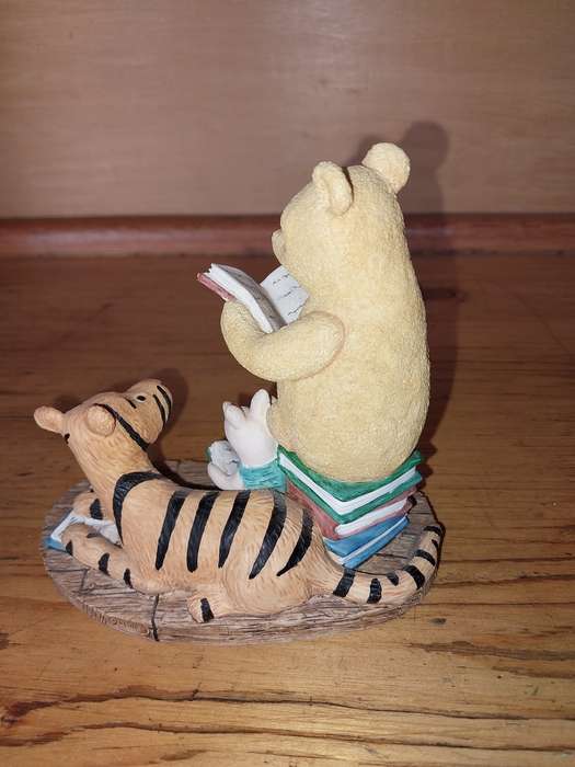 Collectable pooh bear reading ornament