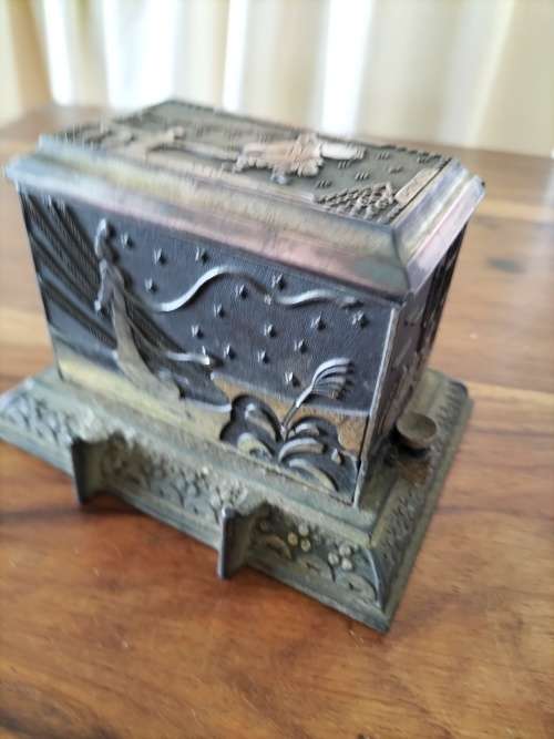 An antique metal cigarette dispenser - still dispenses