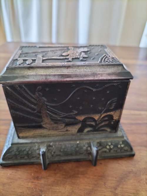 An antique metal cigarette dispenser - still dispenses