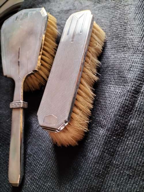 A VINTAGE BIRMINGHAM SILVER HAIRBRUSH AND CLOTHES BRUSH