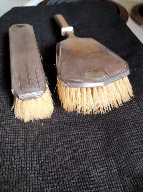 A VINTAGE BIRMINGHAM SILVER HAIRBRUSH AND CLOTHES BRUSH