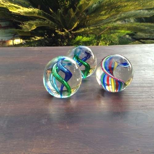3x glass ball paperweight