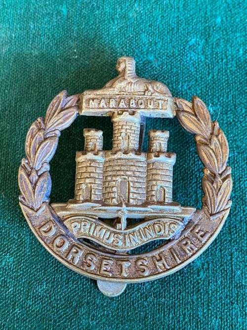 DORSETSHIRE REGIMENT CAP B ADGE WITH SLIDER-WORN 1898-1952