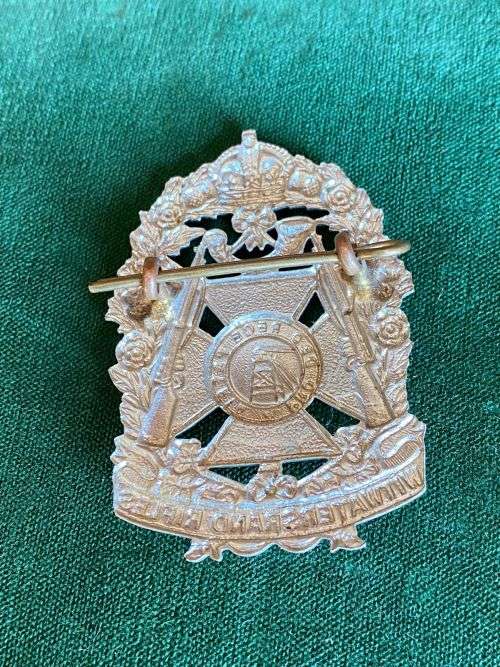 WITWATERSRAND RIFLES CAP BADGE-WORN 1913-1963- WHITE METAL- 2 LUGS