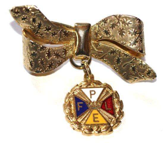 ELEGANT VINTAGE BOW BROOCH WITH ENAMELLED CHARM