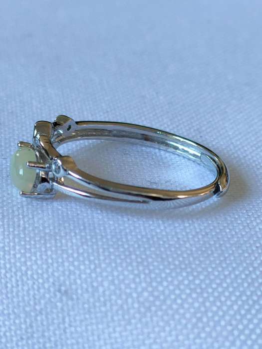 Sterling Ethiopian Opal and White Topaz ring: Size: Adjustable Weight: 0.80.ct+