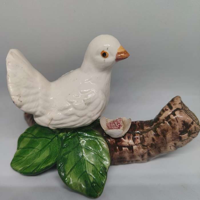 Little white dove on a log figurine.