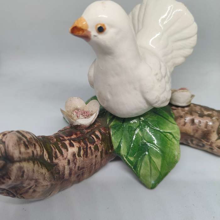 Little white dove on a log figurine.