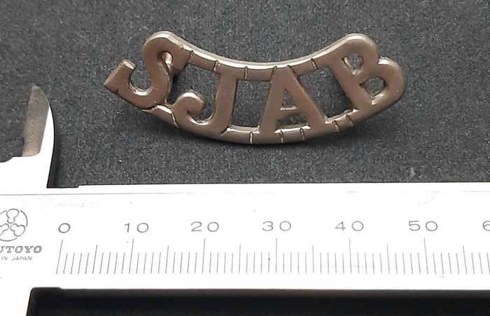 **WW2 St. John Ambulance White Metal Shoulder Title (Lugs Intact).**