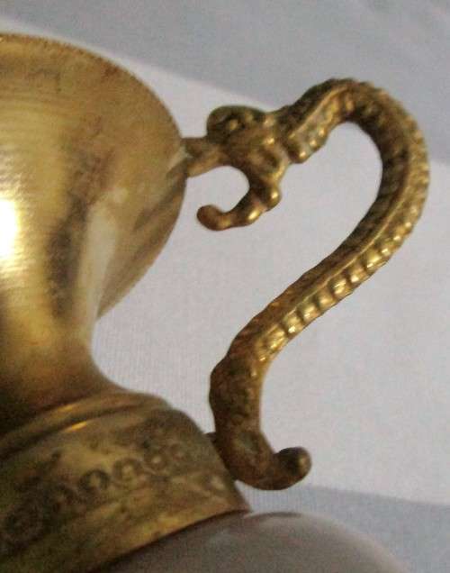Cute urn style Brass bud vase with carved onyx accent. The onxy grain is white in color
