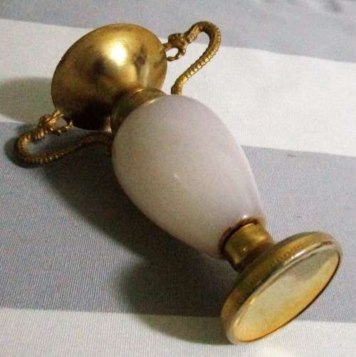 Cute urn style Brass bud vase with carved onyx accent. The onxy grain is white in color