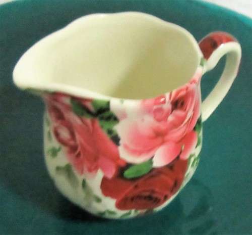 A STUNNING FLORAL VICTORIAN ROSE MILK CREAMER BY WILLIAM JAMES -