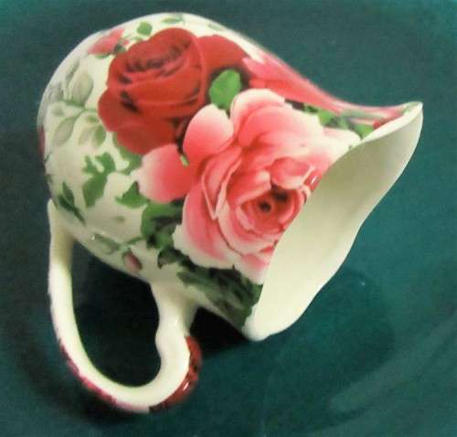 A STUNNING FLORAL VICTORIAN ROSE MILK CREAMER BY WILLIAM JAMES -