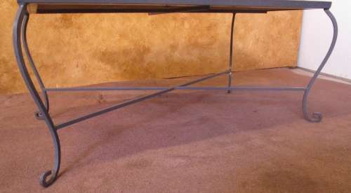 A GORGEOUS OUTDOOR TABLE WITH STEEL LEGS AND FRAME WITH A SOLLID MOSAIC TOP