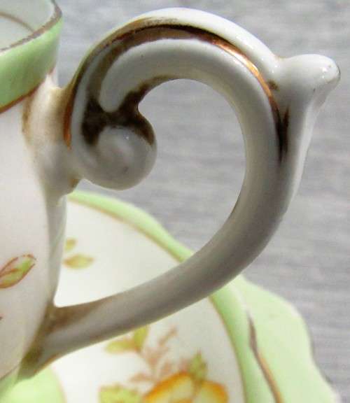 This lovely mid-century tea cup Trio set  were made in England by Bell China.
