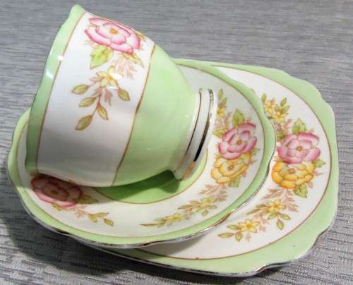 This lovely mid-century tea cup Trio set  were made in England by Bell China.