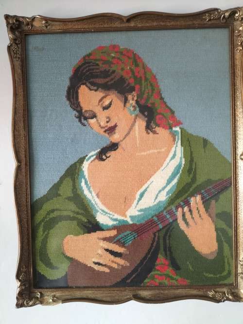 Framed Tapestry of Girl playing an Instrument.