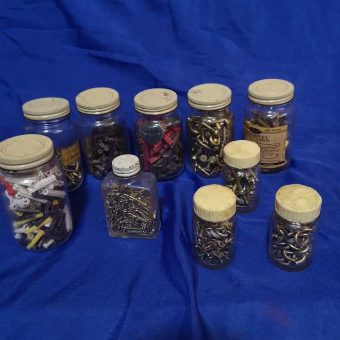 Vintage bottles with vintage brass hardware items. Ideal as garage decor or useable items