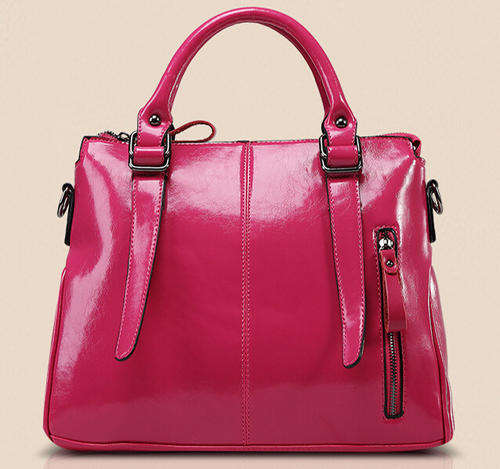 Smooth surface elegant consice ladies handbag with strape. Pink color. Stock in ZA
