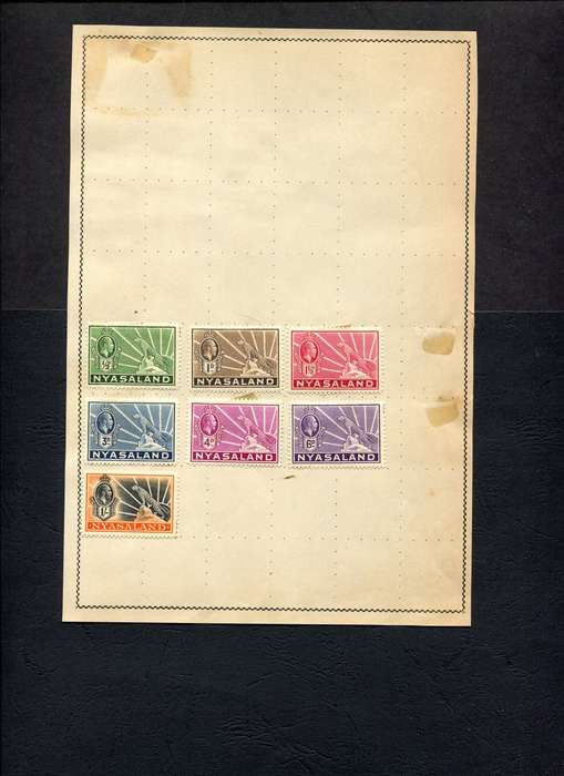 Nyasaland - 7 Stamps Mounted (Hinged) On Old Album Page