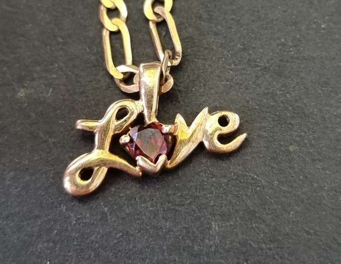 9CT `FIGARO CHAIN` / Heart shape `GARNET` Set in a `LOVE` Pendant ( Genuine Gold )
